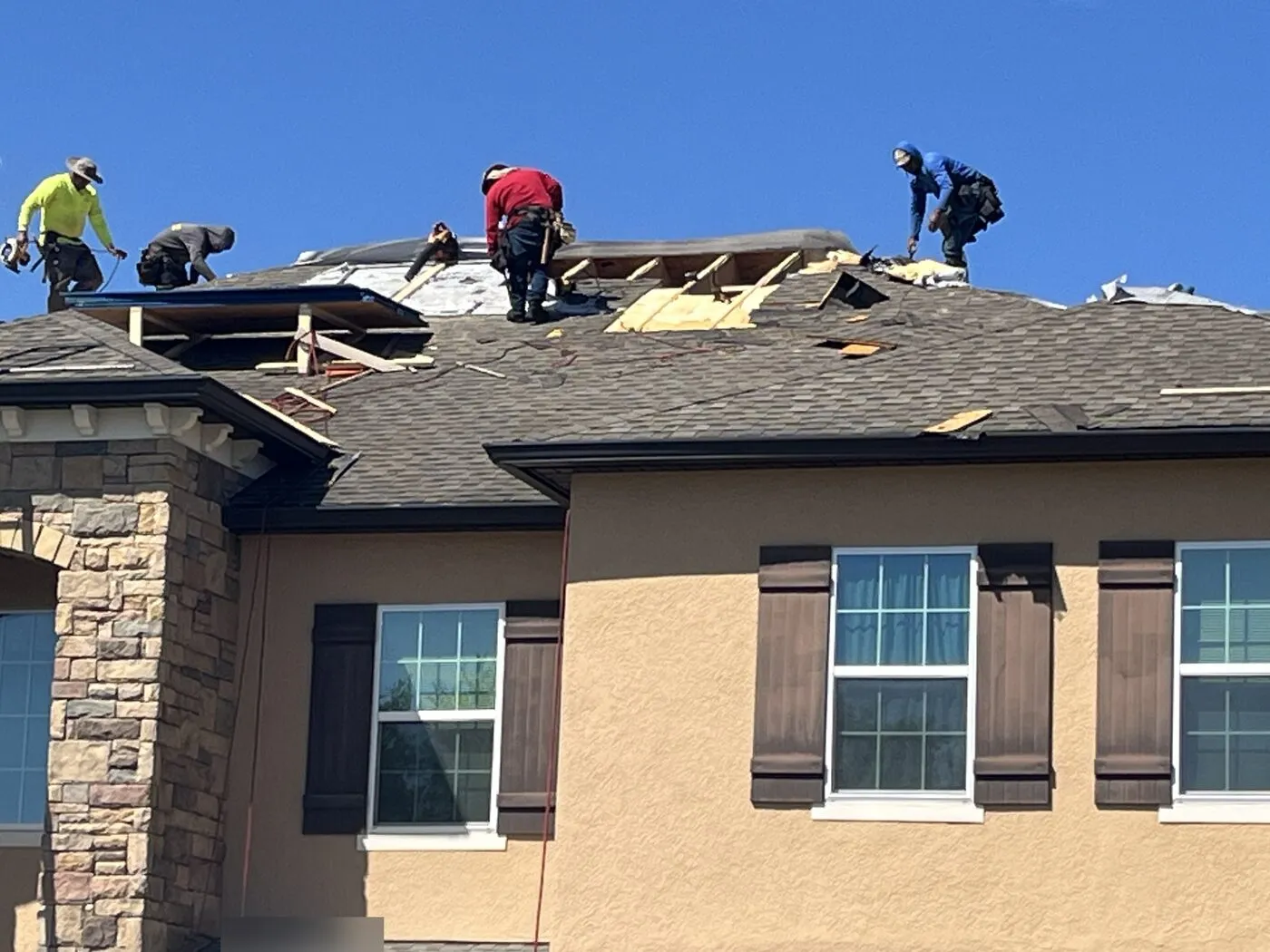 One World Roofing crew performing a roof tear-off in Central Florida