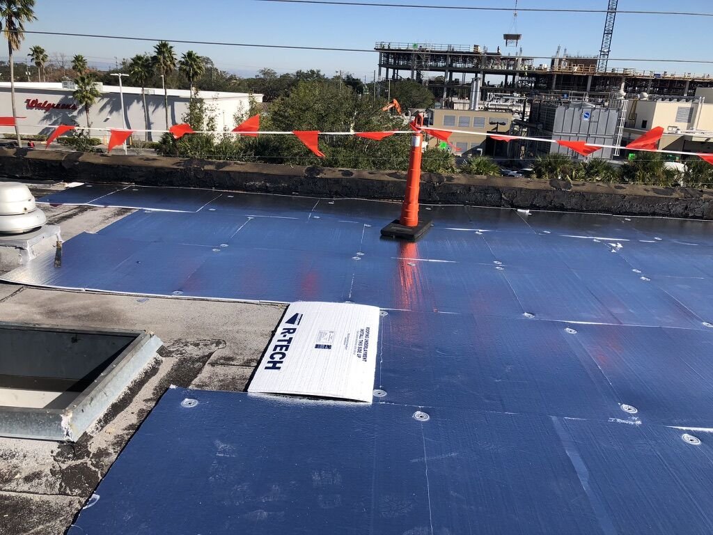 Commercial flat roof insulation boards with fasteners and open curb in Winter Park, FL