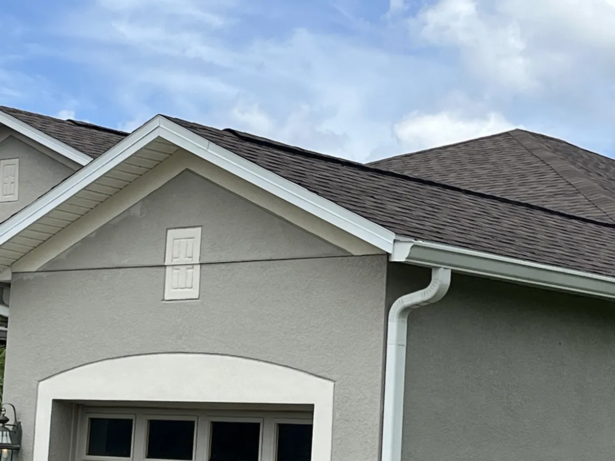 Architectural shingle roof on a stucco home in Lake Pickett, FL by One World Roofing LLC