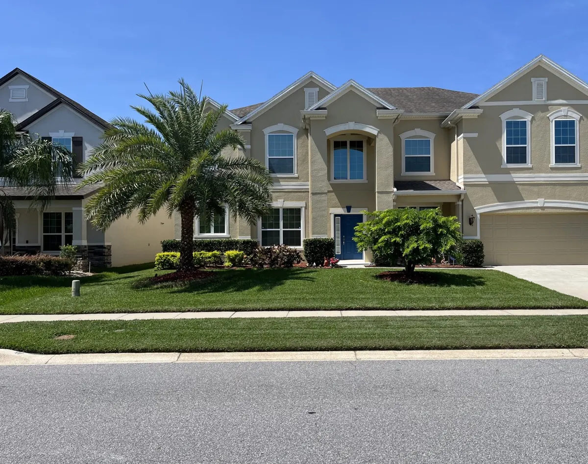 Shingle roof on a two-story home in Lake Pickett, FL by One World Roofing LLC