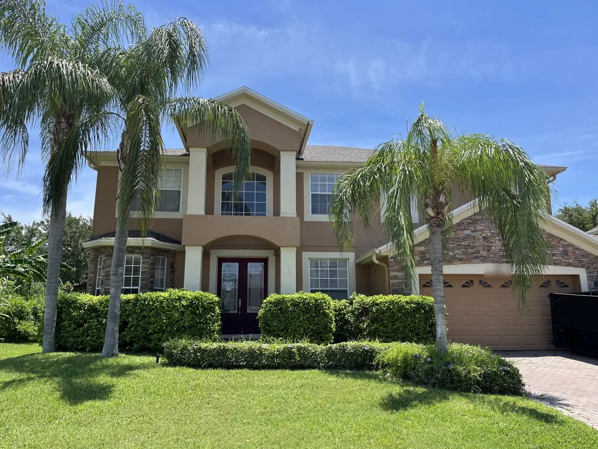 Shingle roof on a two-story home in Ocoee, FL by One World Roofing LLC