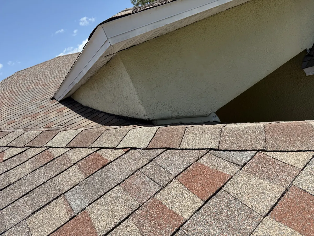 Shingle roof valley and wall detail in Winter Garden, FL by One World Roofing LLC